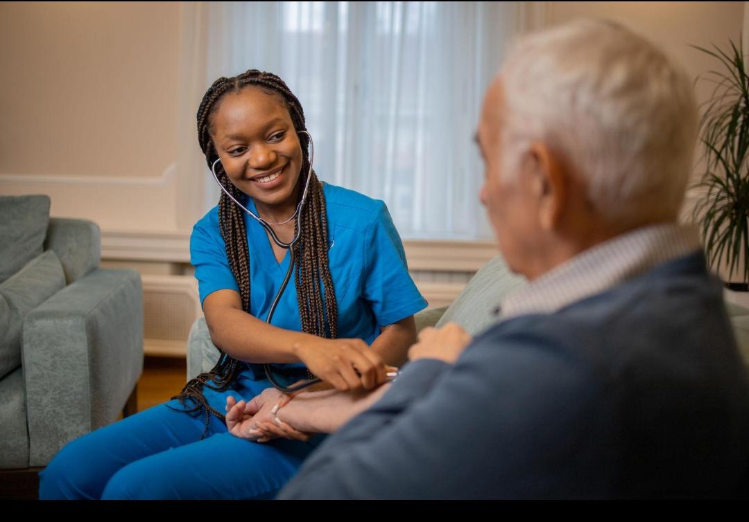 Smiling nurse caring for patient